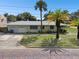 Ranch-style home with attached two-car garage and mature landscaping at 7979 Garden N Dr, St Petersburg, FL 33710