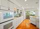 Kitchen features ocean views, white cabinets, and hardwood floors at 20052 Gulf Blvd, Indian Shores, FL 33785