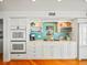 Bright kitchen with white cabinets, teal backsplash, and stainless steel appliances at 20052 Gulf Blvd, Indian Shores, FL 33785