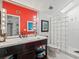 Bright bathroom features a glass block shower and modern vanity at 20052 Gulf Blvd, Indian Shores, FL 33785