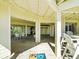 Covered patio with multiple seating areas and access to the beach at 20052 Gulf Blvd, Indian Shores, FL 33785