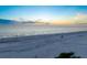 Scenic beach view at sunset with people enjoying the sand at 20052 Gulf Blvd, Indian Shores, FL 33785