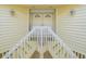 Elevated home with double doors and white railings at 20052 Gulf Blvd, Indian Shores, FL 33785