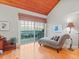 Bedroom with ocean view, chaise lounge, and hardwood floors at 20052 Gulf Blvd, Indian Shores, FL 33785