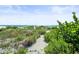 Sandy pathway to the beach with lush vegetation at 20052 Gulf Blvd, Indian Shores, FL 33785