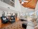 Two-story living room with hardwood floors, vaulted ceiling, and ocean views at 20052 Gulf Blvd, Indian Shores, FL 33785