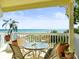 Beachfront balcony boasts stunning ocean views and seating for four at 20052 Gulf Blvd, Indian Shores, FL 33785