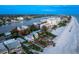 Aerial view of beach house and surrounding area at sunset at 20052 Gulf Blvd, Indian Shores, FL 33785