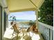 Oceanfront balcony with table and chairs for dining at 20052 Gulf Blvd, Indian Shores, FL 33785