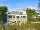 Front view of beach house with wrap around porch at 20052 Gulf Blvd, Indian Shores, FL 33785