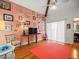 Bedroom with coral rug, hardwood floors, and a wall of artwork at 20052 Gulf Blvd, Indian Shores, FL 33785