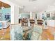 Open kitchen with breakfast bar, white cabinets, and views into living room at 20052 Gulf Blvd, Indian Shores, FL 33785