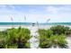 Scenic beach view with calm ocean and lush vegetation at 20052 Gulf Blvd, Indian Shores, FL 33785