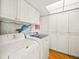 Convenient laundry room with washer, dryer, and ample storage at 20052 Gulf Blvd, Indian Shores, FL 33785