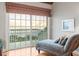 Bedroom with ocean view, chaise lounge, and hardwood floors at 20052 Gulf Blvd, Indian Shores, FL 33785