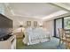 Bright bedroom with a king-size bed and access to a balcony at 36750 Us Highway 19 # 23-110, Palm Harbor, FL 34684
