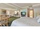 Bedroom with a king bed and view into kitchen and dining areas at 36750 Us Highway 19 # 23-110, Palm Harbor, FL 34684