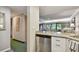 Kitchen with granite countertop, stainless steel dishwasher, and white cabinets at 36750 Us Highway 19 # 23-110, Palm Harbor, FL 34684