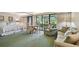 Main bedroom with sitting area and sliding glass doors to patio at 36750 Us Highway 19 # 23-110, Palm Harbor, FL 34684