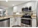 Modern kitchen with stainless steel appliances and granite countertops at 36750 Us Highway 19 # 23-110, Palm Harbor, FL 34684