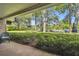 Brick patio with seating area and view of lush landscaping and parking lot at 36750 Us Highway 19 # 23-110, Palm Harbor, FL 34684