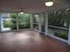 Spacious screened porch with tile flooring and ceiling fans at 5 158Th Ave, Redington Beach, FL 33708