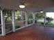 Bright screened porch with tile floor and lush garden view at 5 158Th Ave, Redington Beach, FL 33708