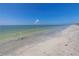 Relaxing beach scene with gentle waves and clear water at 5 158Th Ave, Redington Beach, FL 33708