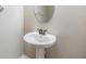 Bathroom featuring white pedestal sink and simple lines at 1821 Cherry Walk Rd, Lutz, FL 33558