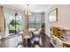 Bright dining area with natural light, modern lighting fixture and sliding door access to outdoor patio at 1821 Cherry Walk Rd, Lutz, FL 33558