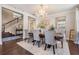 Dining room featuring a wood table, chandelier, gray chairs, wall art, and hardwood floors at 1821 Cherry Walk Rd, Lutz, FL 33558