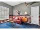 Comfortable living room with red couch, a window, and decorative wall hangings at 1852 Longview Ln, Tarpon Springs, FL 34689