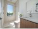 Bright bathroom featuring a shower and sink, complemented by light-colored floors and large window at 2721 17Th N Ave, St Petersburg, FL 33713