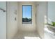 Bright bathroom featuring a shower with full view window, complemented by textured tile and flooring at 2721 17Th N Ave, St Petersburg, FL 33713
