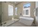 Bright bathroom featuring a modern soaking tub, a walk-in shower with glass door, and neutral-toned walls and floors at 2721 17Th N Ave, St Petersburg, FL 33713