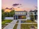Modern two-story home with a gray and white exterior, a walkway, and landscaping at 2721 17Th N Ave, St Petersburg, FL 33713