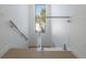 Minimalist staircase design featuring glass railings and modern fixtures, enhancing natural light at 2721 17Th N Ave, St Petersburg, FL 33713