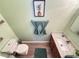 Well-lit bathroom featuring modern fixtures, wood-look floors, and fresh decor at 6546 Marlberry Way, Largo, FL 33773