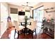 Cozy dining area with a glass table, stylish chairs, and sliding glass doors to outdoor area at 6546 Marlberry Way, Largo, FL 33773