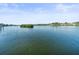 Scenic view of calm water with lush greenery and distant houses at 20051 Gulf Blvd, Indian Shores, FL 33785
