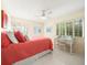 Comfortable bedroom with coral bedding and a workspace at 20051 Gulf Blvd, Indian Shores, FL 33785