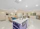 Open concept kitchen with white cabinets, purple island, and living room view at 20051 Gulf Blvd, Indian Shores, FL 33785