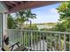 Relaxing balcony overlooking peaceful waterfront with lush tropical foliage at 20051 Gulf Blvd, Indian Shores, FL 33785