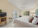 Main bedroom with king bed, balcony access, and lots of natural light at 20051 Gulf Blvd, Indian Shores, FL 33785