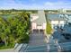 Elevated view of canal-front home with parking and nearby businesses at 20051 Gulf Blvd, Indian Shores, FL 33785