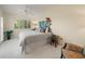 Bright bedroom featuring a king-size bed and access to a balcony at 20051 Gulf Blvd, Indian Shores, FL 33785