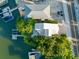 Aerial view of waterfront home with private dock and boat at 20051 Gulf Blvd, Indian Shores, FL 33785