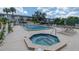 Relaxing community pool and hot tub area with ample lounge chairs at 5817 Park N St # 402, St Petersburg, FL 33709