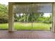 Peaceful screened porch overlooking a lush backyard at 1852 Longview Ln, Tarpon Springs, FL 34689