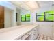 Bathroom with large vanity, tiled floor and dual windows at 15350 Scanio Dr, Spring Hill, FL 34610